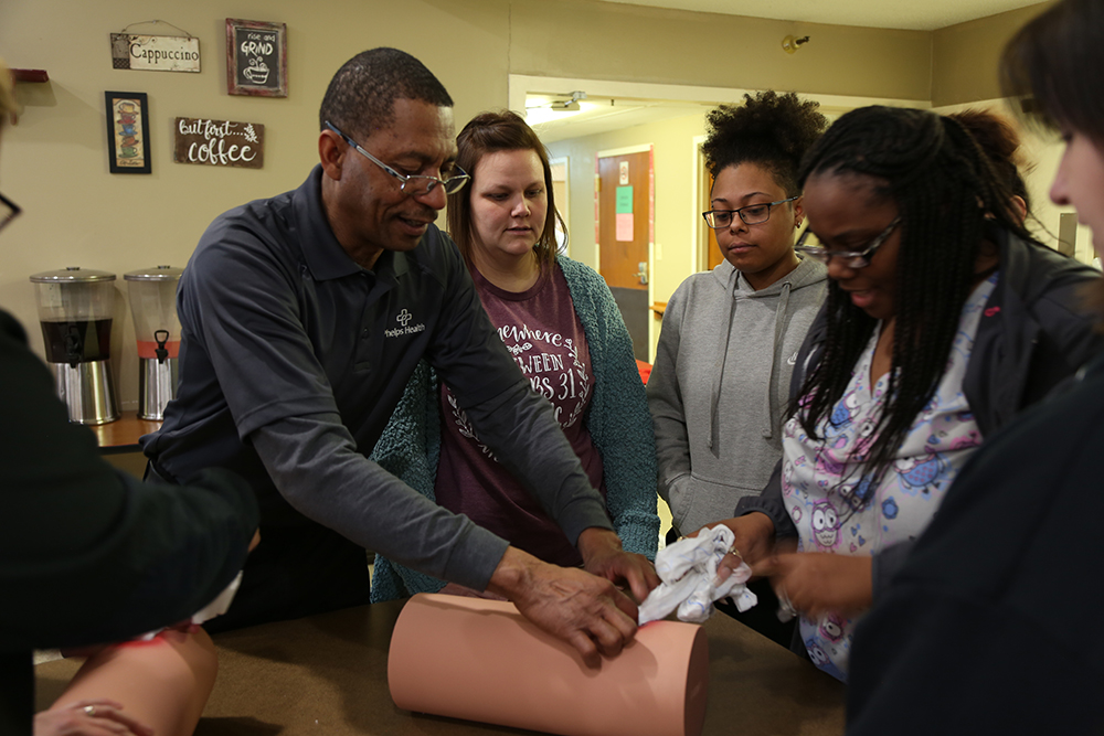 Phelps Health instructor teaching students to control bleeding