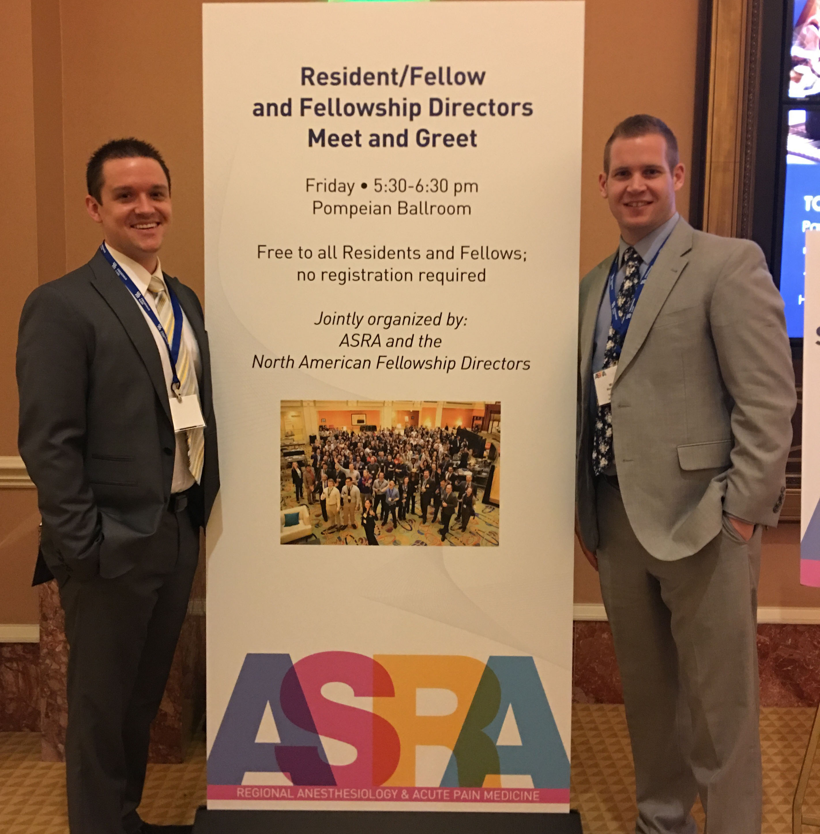 medical students stand next to ASRA conference poster