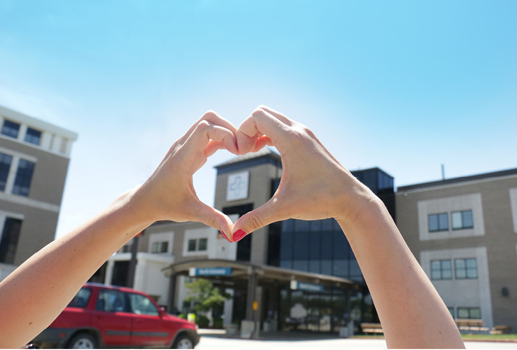 Hand heart over Phelps Health campus