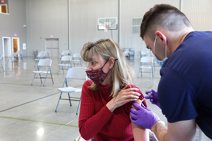Woman receiving COVID-19 vaccine