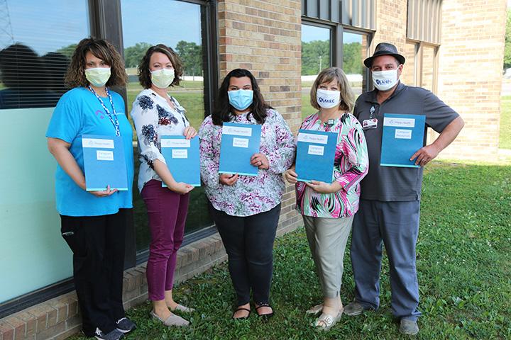 Care manager and Mid-MO AHEC shown with caregiver resource packets