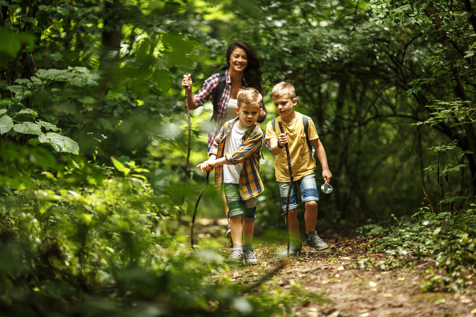 Mom and kids hiking in woods