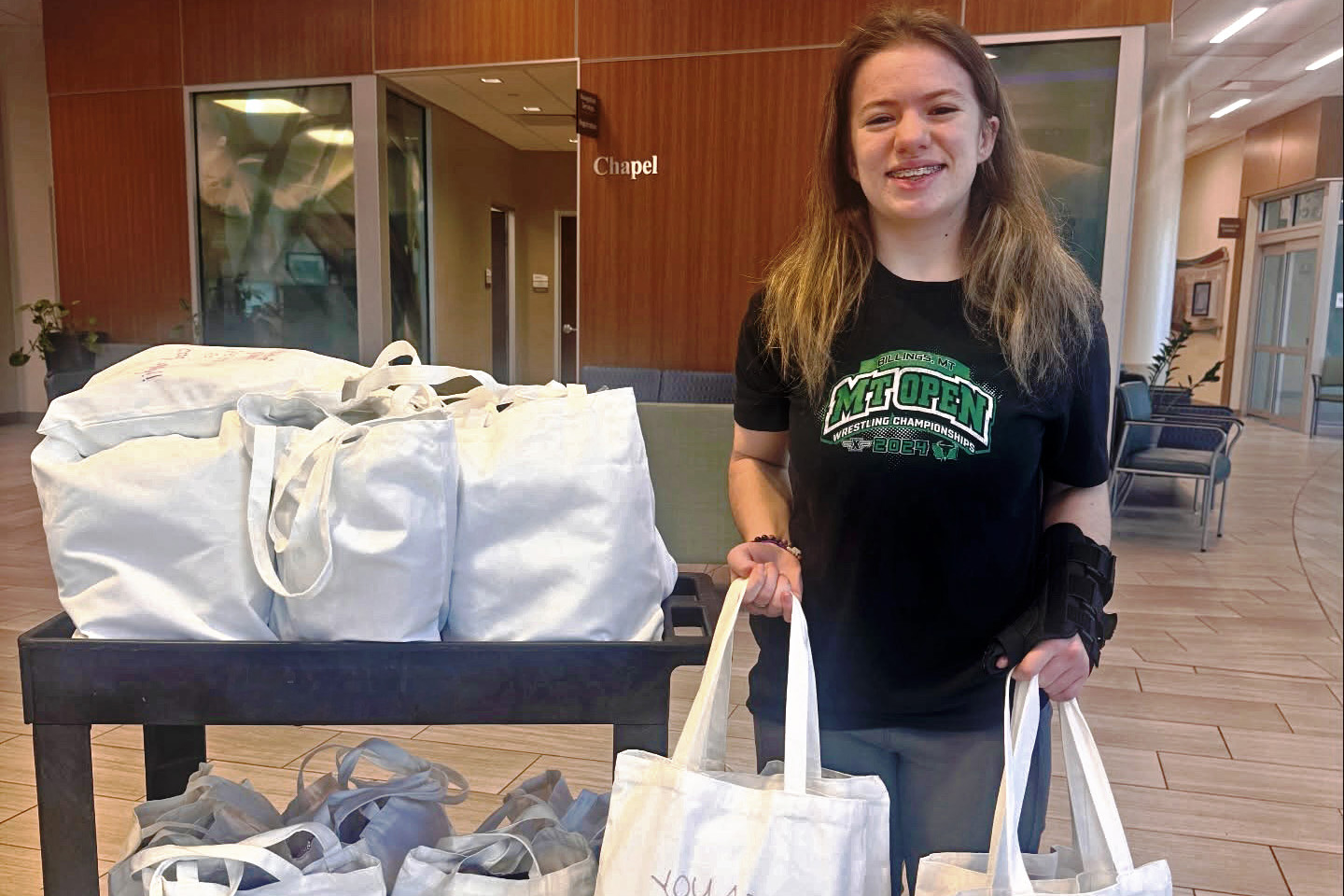 Brooklyn Raines distributes cancer comfort kits to patients at the Phelps Health Delbert Day Cancer Institute