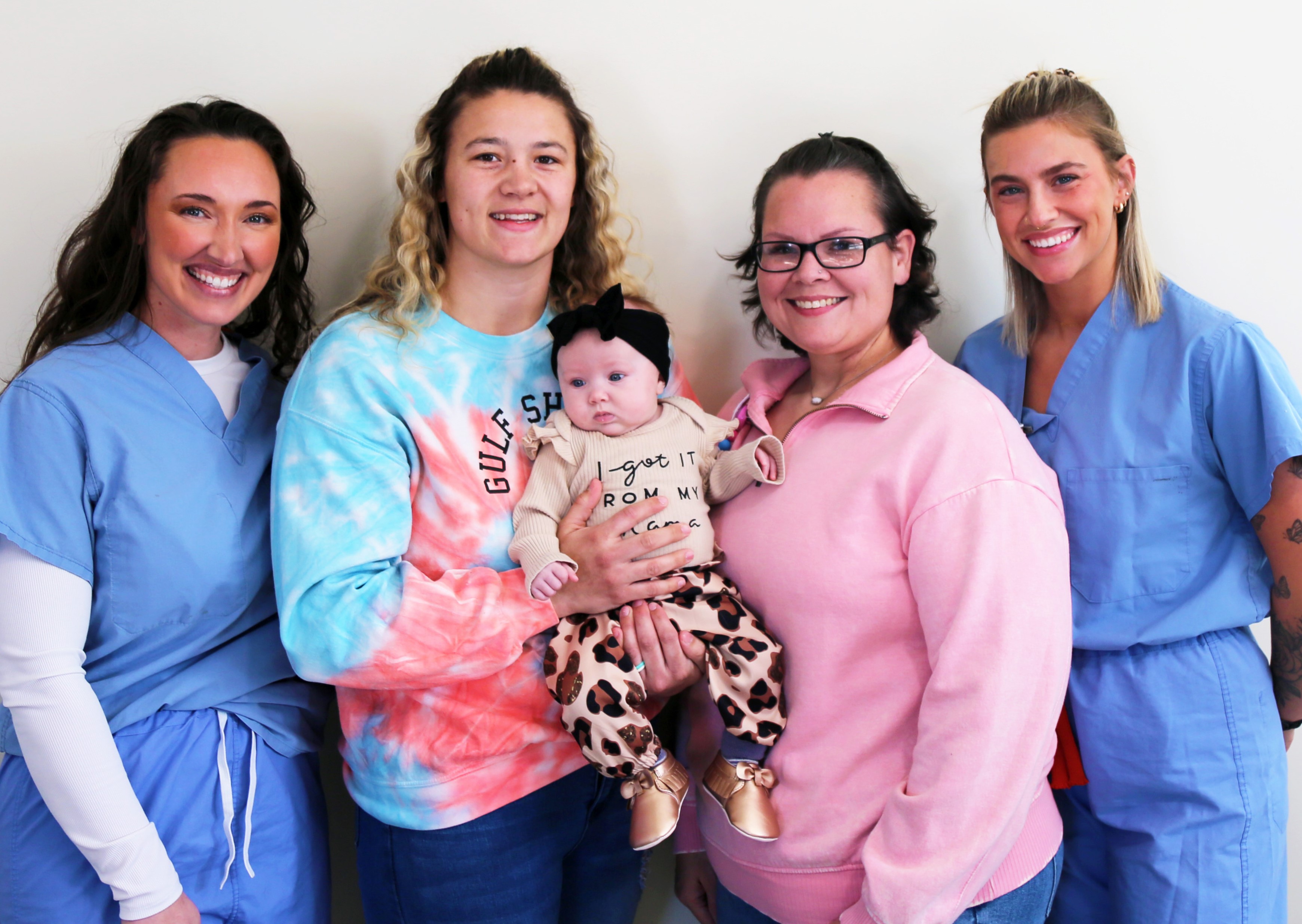 Amy Harris, RN; Heather Achterberg; Paige Alvarado, CNM; and Natalie Look, BSN, RN, pose with baby Nataley