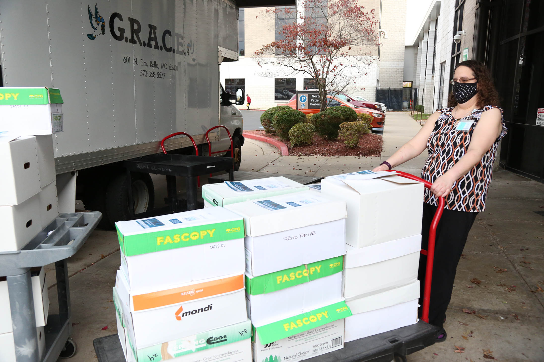 Crystal Lorah pulls cart of food donations