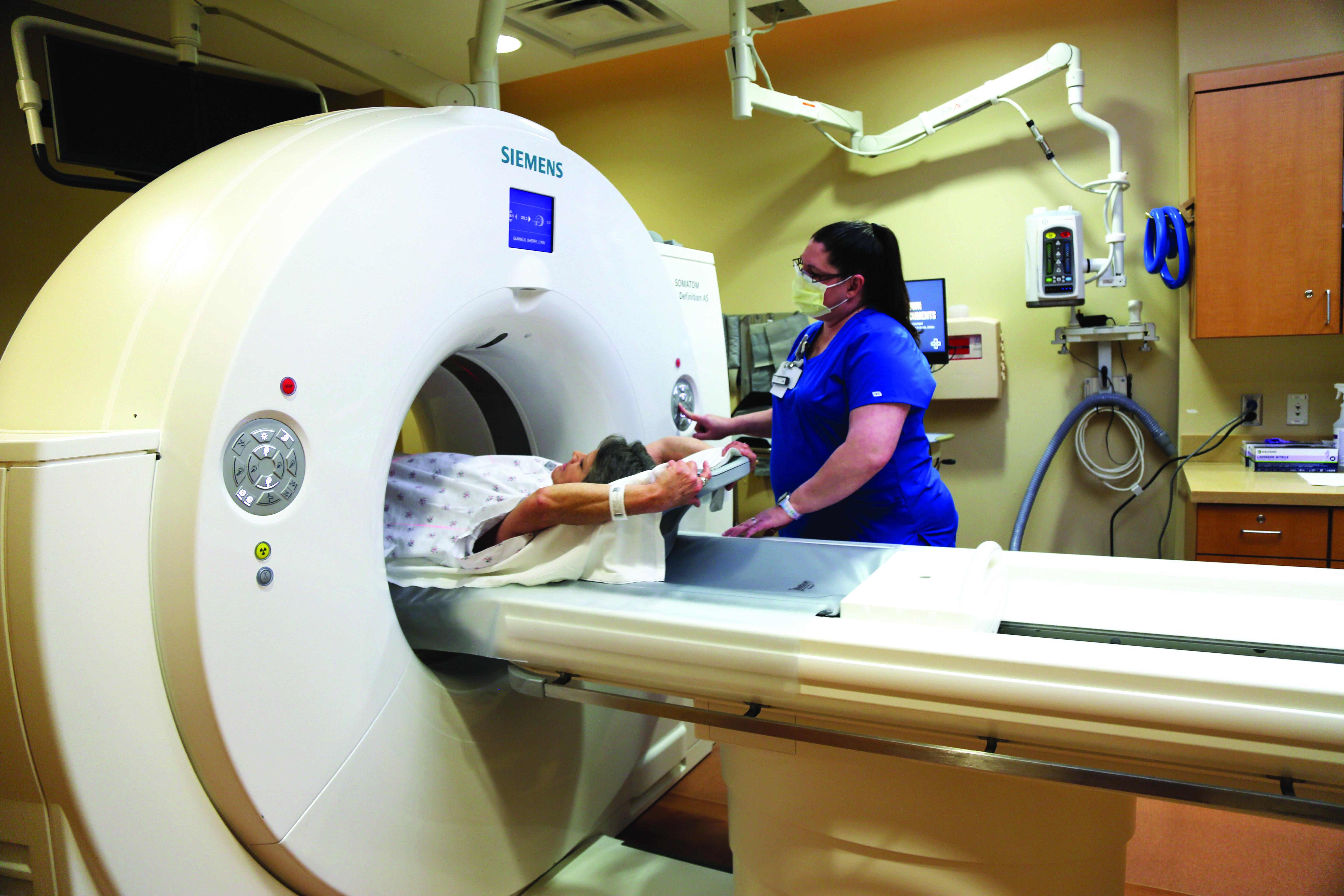Woman getting a CT scan for screen for lung cancer