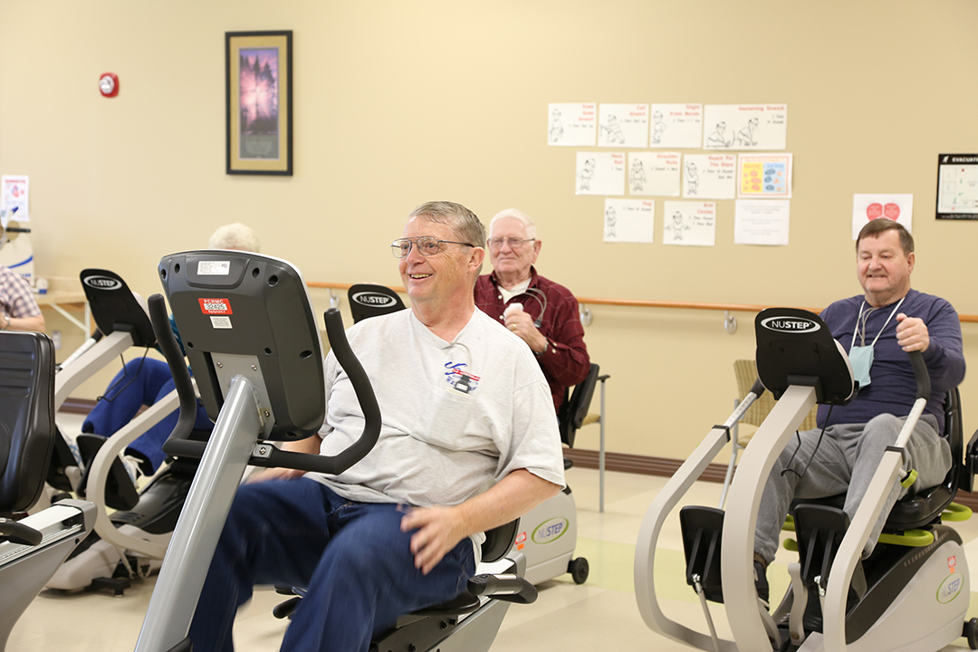Patients on equipment at cardiac rehab gym