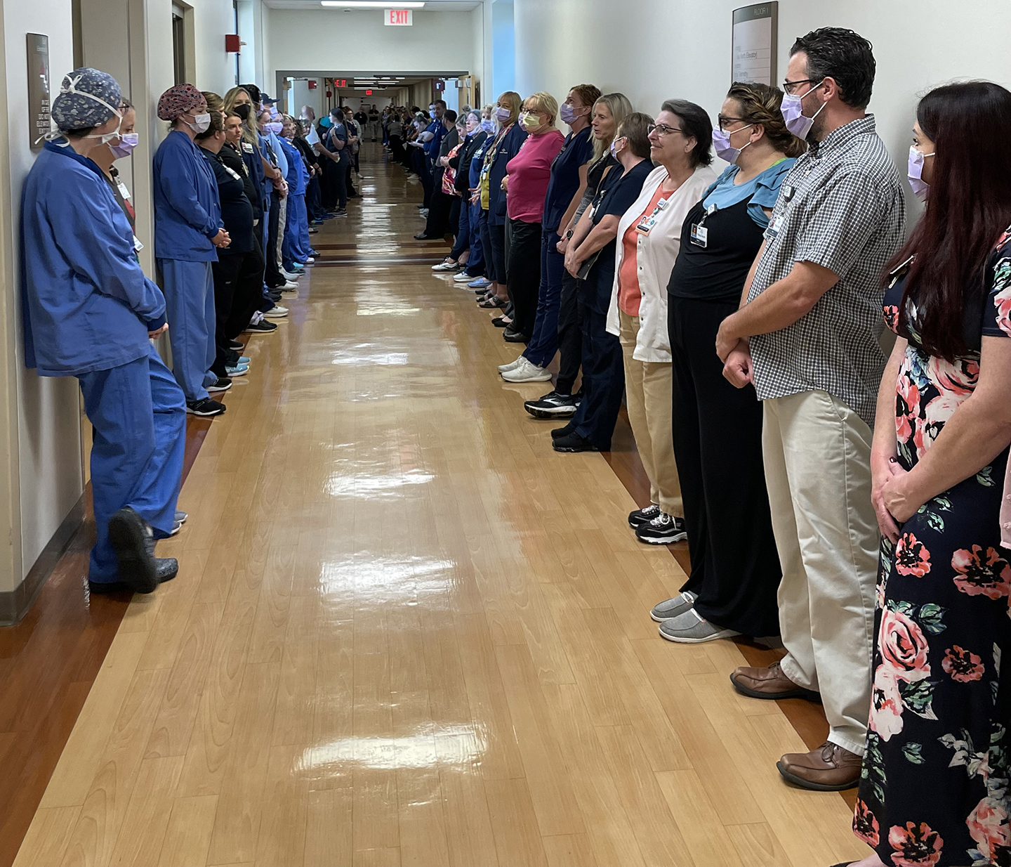 Phelps Health employees line hall for Code Hero in honor of donor