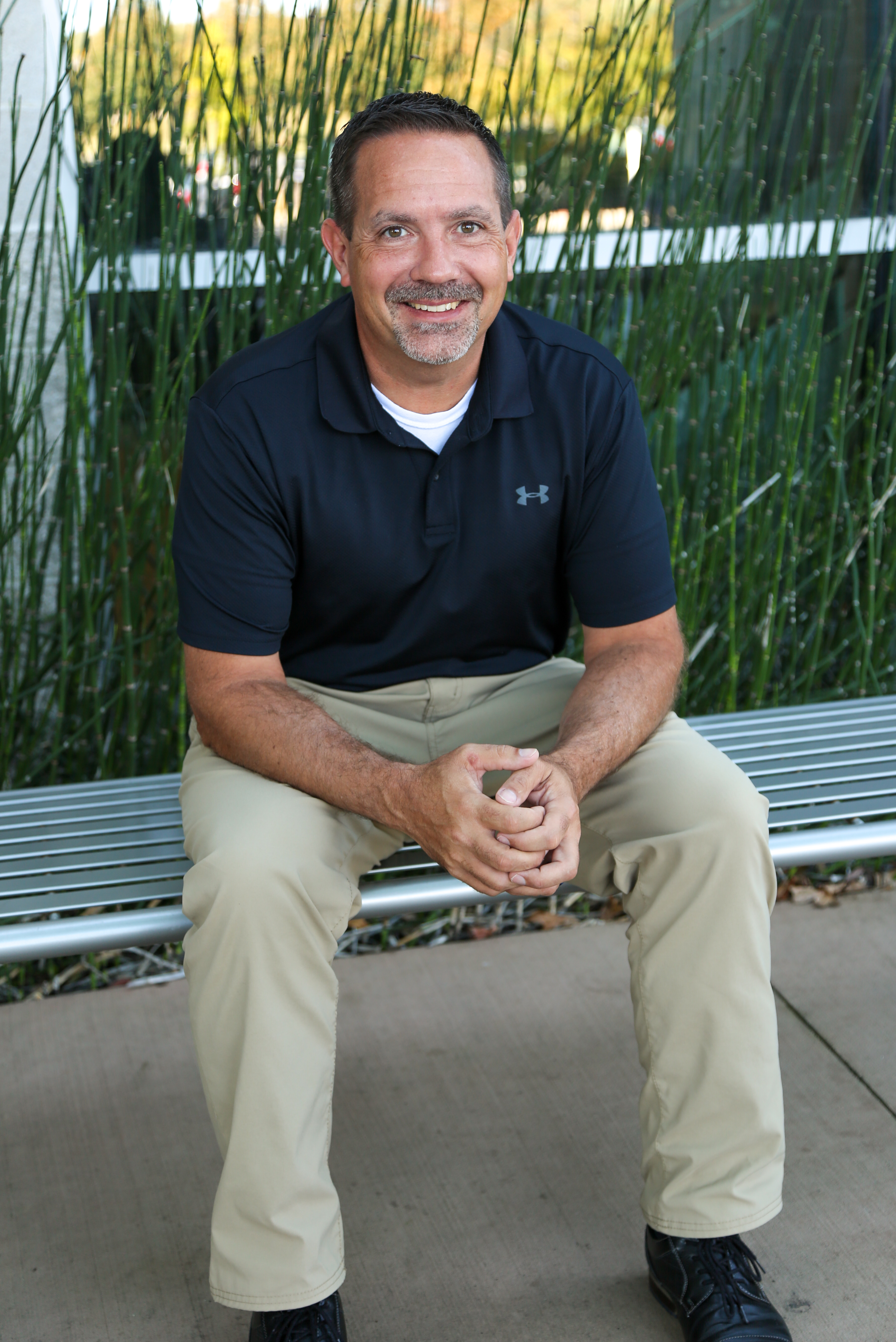 Jason Shenefield sits on a bench outside of the DDCI building.