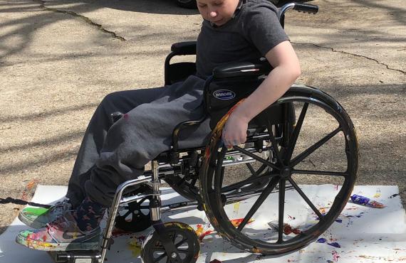 Dylan, a Phelps Health Homecare patient, painting with his wheelchair 