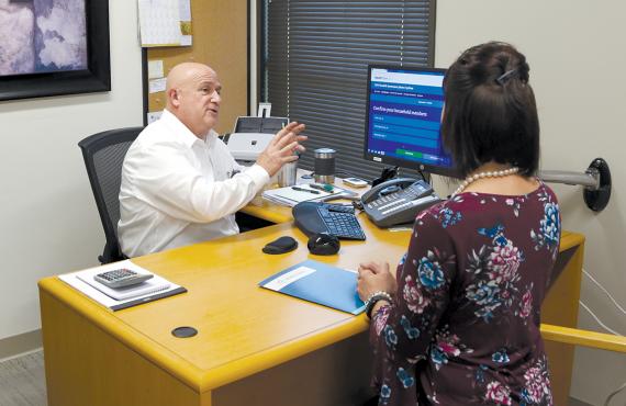 EnrollU staff at Phelps Health helping individual