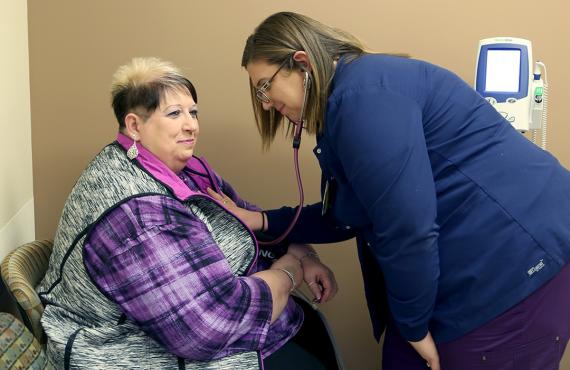 Nurse checking blood pressure of patient Nurse checking blood pressure of patient