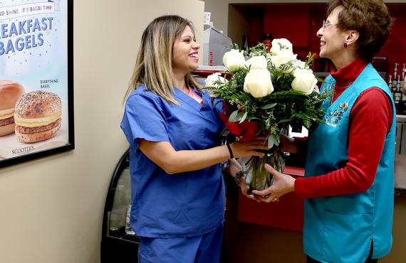 Volunteer giving flowers