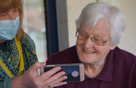 senior patient looking at phone