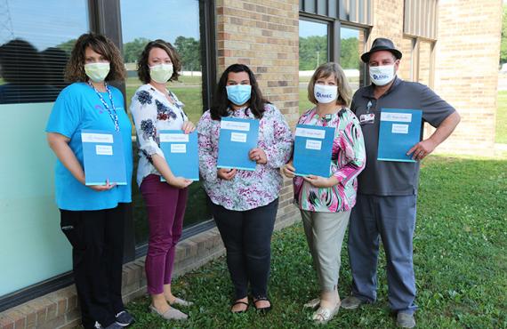 Caregiver Resource Packets Care manager and Mid-MO AHEC shown with caregiver resource packets