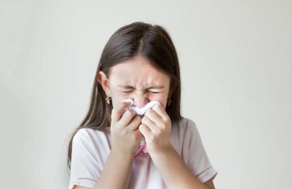 Girl blowing nose