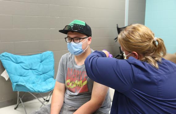 A student gets a COVID vaccine
