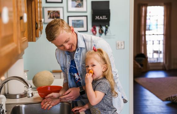 A father cooks with his daughter