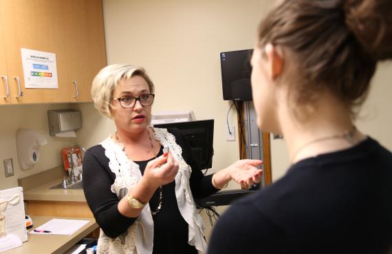 Heather Request, WHNP, CNM, talks with a patient