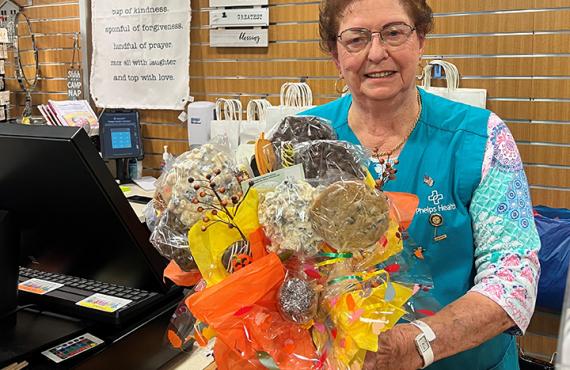 Auxiliary member Mabel Godfrey with bouquet of flowers