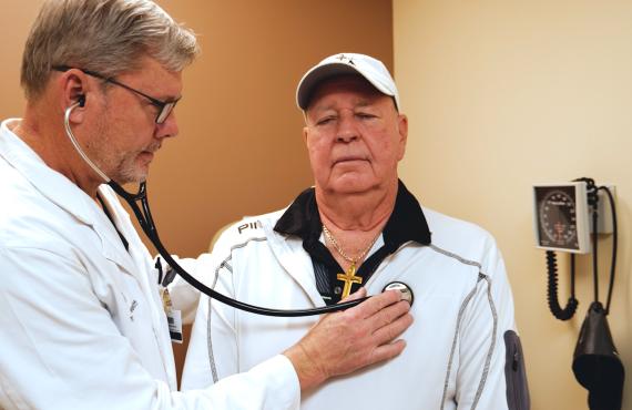 Phelps Health Cardiologist Tim Martin, MD, checks patient Chet Saladin's heart.