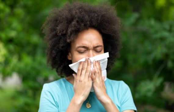 A woman sneezing