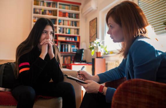 Therapist talking to a patient