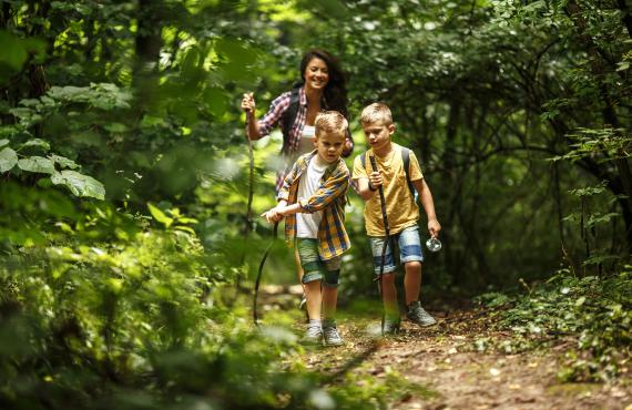 Mom and kids hiking in woods