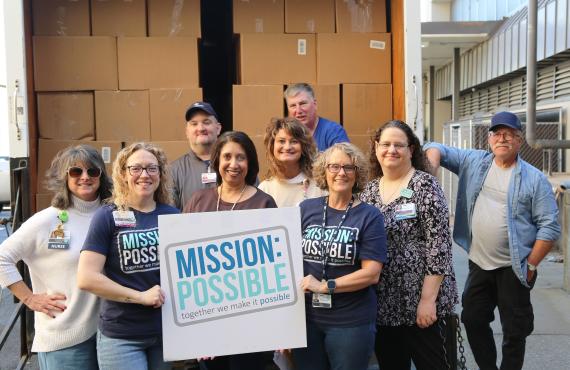 Phelps Health employees with boxes of donated food.