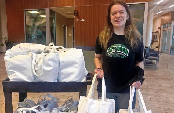 Brooklyn Raines distributes cancer comfort kits to patients at the Phelps Health Delbert Day Cancer Institute