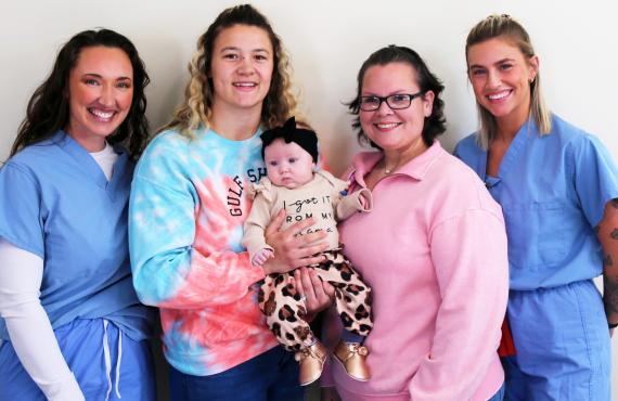 Amy Harris, RN; Heather Achterberg; Paige Alvarado, CNM; and Natalie Look, BSN, RN, pose with baby Nataley